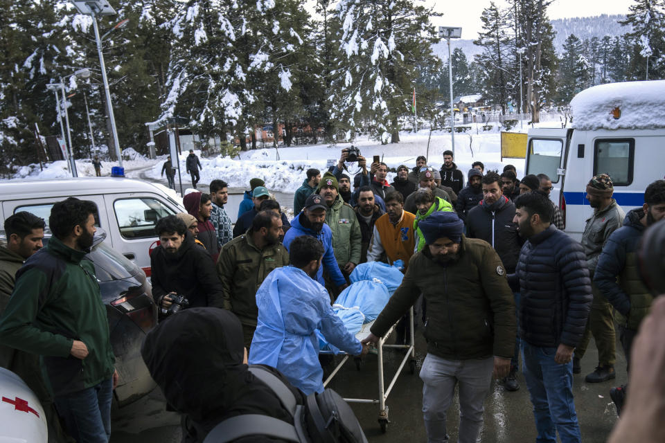 A paramedic and volunteers transport the body of a Russian skier to a hospital in Tangmarg, near Gulmarg, a popular skiing destination in Indian controlled Kashmir, Thursday, Feb. 22, 2024. Officials say that the Russian skier was killed by an avalanche that hit Gulmarg on Thursday. (AP Photo/Dar Yasin)