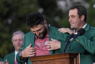 Scottie Scheffler puts the green jacket on Jon Rahm, of Spain, after Rahm won the Masters golf tournament at Augusta National Golf Club on Sunday, April 9, 2023, in Augusta, Ga. (AP Photo/Jae C. Hong)