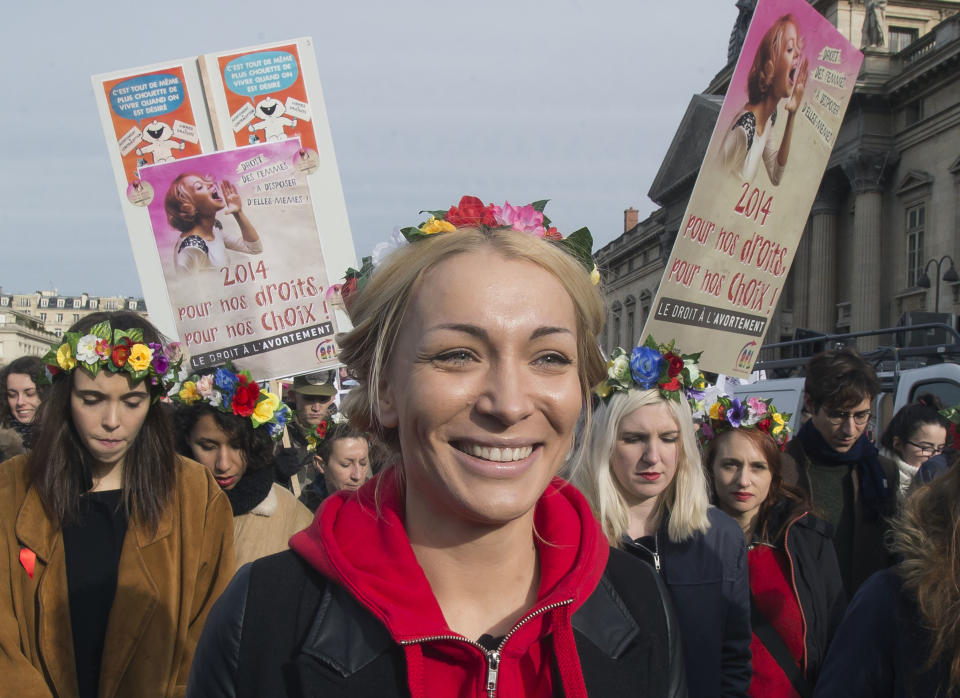 Leader of the feminist protest group Femen Ukrainian Inna Shevchenko, marches during a rally with their group members to protest against the new abortion law in Spain, in Paris, Saturday Feb. 1, 2014. Spain's conservative government approved tight restrictions on abortion, allowing the practice only in the case of rape or when there is a serious health risk to the mother or fetus. Placards read, "2014 for our rights we choose". (AP Photo/Michel Euler)