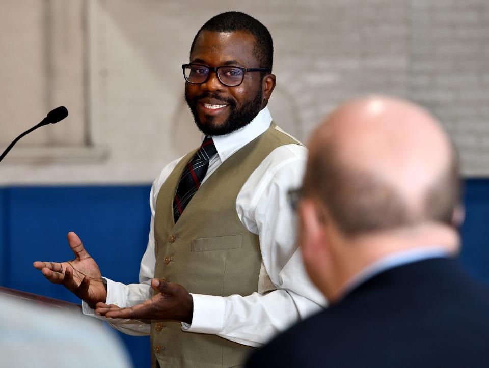 African Community Education Career Development Program Coordinator and former ACE student Saint Cyr Dimanche thanks U.S. Rep. James P. McGovern and ACE Executive Director and Co-Founder Kaska Yawo during Friday's funding announcement in Worcester.