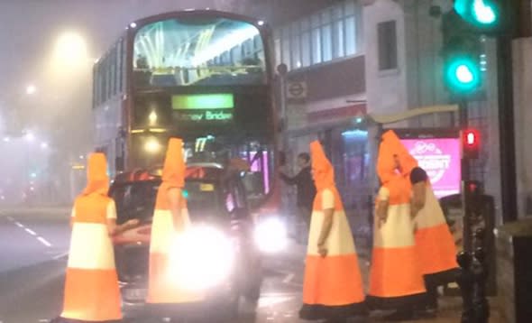 Police called over men dressed as traffic cones blocking cars