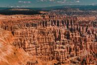 <p><a href="https://www.nps.gov/brca/index.htm" rel="nofollow noopener" target="_blank" data-ylk="slk:Bryce Canyon National Park;elm:context_link;itc:0;sec:content-canvas" class="link ">Bryce Canyon National Park</a> won’t look like anywhere you’ve seen before with thousands of their hoodoos — geological structures formed by frosty weather and steam erosion. You’ll be looking out into a sea of red, orange, and white rocks — and be sure to check out a collection of natural amphitheaters, too. </p><p>Bryce Canyon is located about 50 miles from Zion National Park.</p><p>How many of these did you know was in the United States? Each of these places is a real-life Photoshopped dream. You won’t have to fly across the world to see any of these unreal destinations. Some you can check off your list in one road trip from Arizona, Utah, and California. </p><p>Wherever your next adventure takes you, you won’t have to leave the country to see wonders of the world. </p>