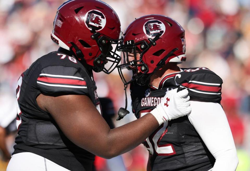 South Carolina linebacker Stone Blanton (52) celebrates a pick-six with teammate offensive lineman Trovon Baugh (78) during the second half of the Gamecocks’ game at Williams-Brice Stadium in Columbia on Saturday, November 4, 2023.