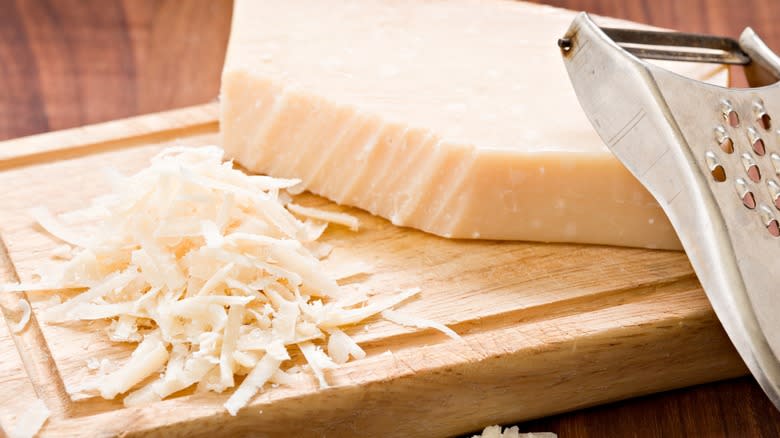 Block of white cheese with shreds