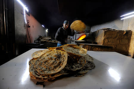 A man prepares bread at a bakery in Deir al-Zor, Syria September 20, 2017. Picture taken September 20, 2017. REUTERS/Omar Sanadiki