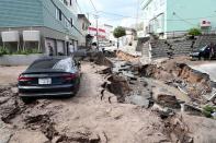 <p>A car is seen stuck on a road damaged by an earthquake in Sapporo, Hokkaido prefecture on Sept. 6, 2018. A powerful 6.6-magnitude quake rocked the northern Japanese island of Hokkaido that day, triggering landslides, collapsing buildings, and killing at least two people with several dozen missing. (Photo from Jiji Press/AFP/Getty Images) </p>