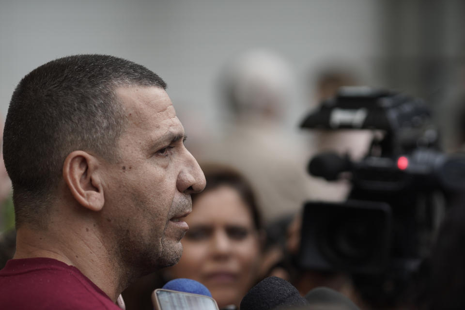 Daniel Freitas, talks to journalists about his mother, Irene Freitas, who died in the fire at the Badim Hospital, outside the the Medical Legal Institute morgue in Rio de Janeiro, Brazil, Friday, Sept. 13, 2019. The fire raced through the hospital in Rio de Janeiro, forcing staff to wheel patients into the streets on beds or in wheelchairs and leaving at least 11 people dead, Brazilian officials said Friday. (AP Photo/Leo Correa)