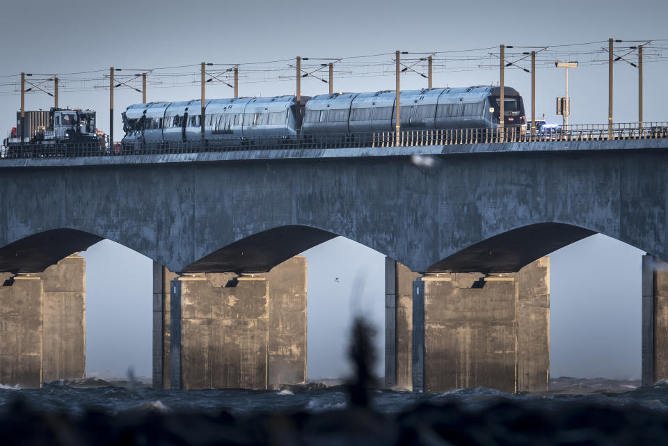 A view of the scene after a train accident on the Great Belt Bridge in Nyborg, Denmark, Wednesday, Jan. 2, 2019. A Danish passenger train apparently hit falling cargo from a passing freight train Wednesday, an accident that killed six people and injured 16 others as it crossed a bridge linking the country's islands, authorities said. Authorities said the trains were going past each other in opposite directions. Aerial TV footage showed one side of front of the passenger train had been ripped open. (Mads Claus Rasmussen/Ritzau Scanpix via AP)