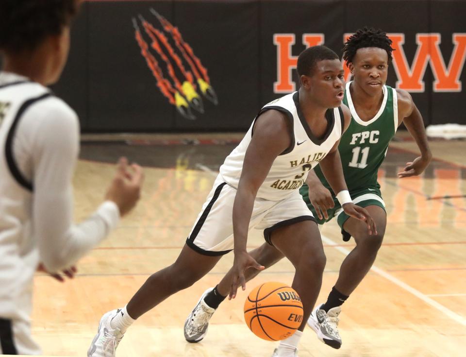 Halifax's Tola Dixon (2) drives past Flagler Palm Coast's Jameer Clark (11), Saturday, Jan. 13, 2024 during the Execute to Impact MLK Showcase Tournament at Spruce Creek High School.