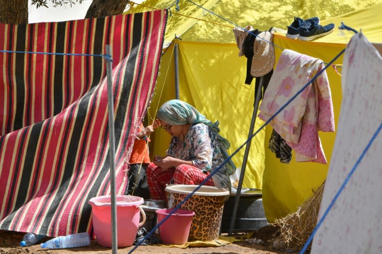 A woman sits outside her tent at a camp for locals displaced by a devastating earthquake in Amizmiz on September 16, 2023 (FETHI BELAID)
