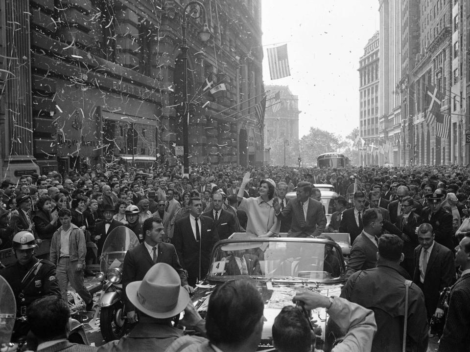 John F. Kennedy and his wife, Jackie, ride in open car up Broadway, in New York, in 1960.