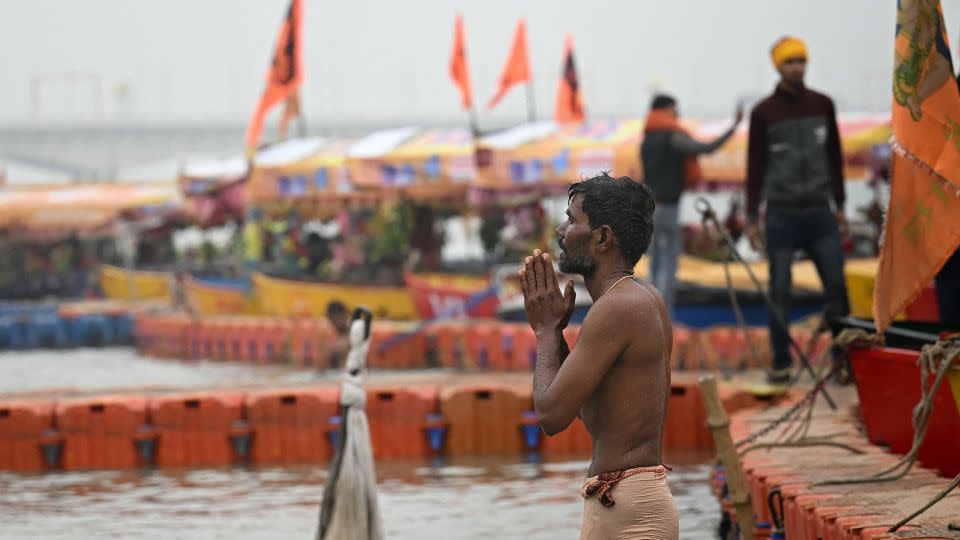 A man prays on the banks of Sarayu River on the occasion of Ram temple's consecration ceremony in Ayodhya on January 22, 2024. - Money Sharma/AFP/Getty Images