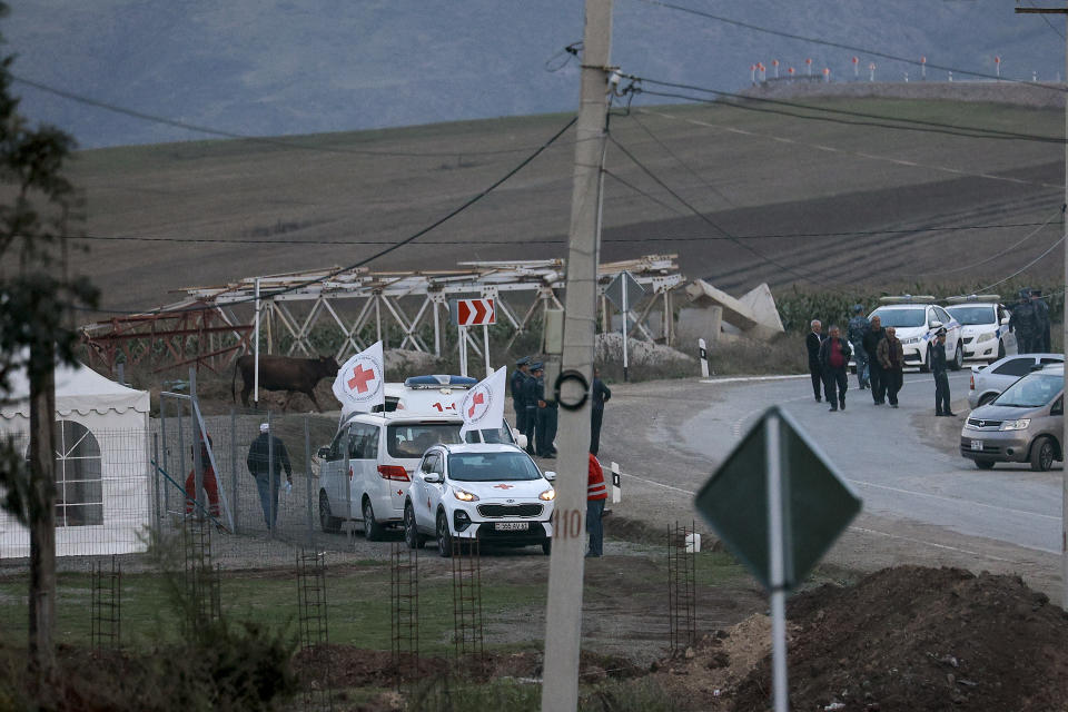 The motorcade with the first group of about 30 people from Nagorno-Karabakh to Armenia's parked at a checkpoint near Kornidzor village in Syunik region, Armenia, Sunday, Sept. 24, 2023. The first refugees from Nagorno-Karabakh have arrived in Armenia, local officials reported Sunday, and more were expected to come after a 10-month blockade and a lightning military offensive this month that resulted in Azerbaijan reclaiming full control of the breakaway region. (AP Photo/Vasily Krestyaninov)