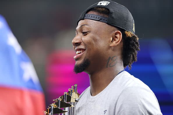 HOUSTON, TEXAS - NOVEMBER 02:  Ronald Acuna Jr. #13 of the Atlanta Braves holds the Commissioner's Trophy following the teams 7-0 victory against the Houston Astros in Game Six to win the 2021 World Series at Minute Maid Park on November 02, 2021 in Houston, Texas. (Photo by Elsa/Getty Images)