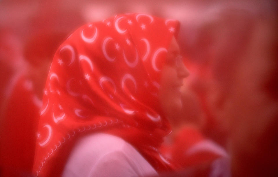 A supporter wearing a headscarf of the Turkish flag