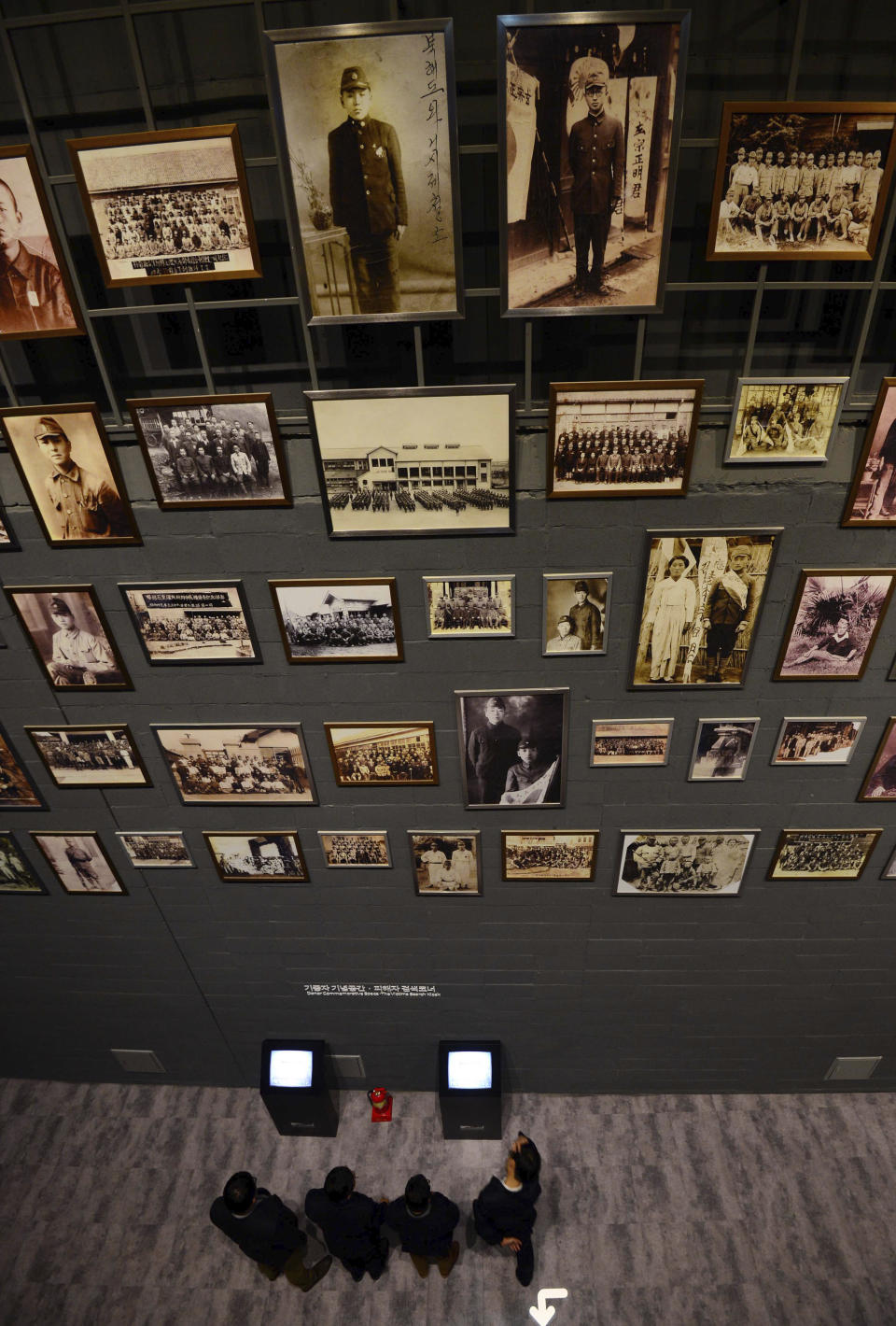 In this Dec. 10, 2015, photo, photos of victims of forced labor during Japan's colonial rule of the Korean Peninsula are displayed at National Memorial Museum of Forced Mobilization under Japanese Occupation in Busan, South Korea. Many Koreans today think Japan still hasn’t fully acknowledged responsibility for its atrocities, and survivors of its forced labor and prostitution are still seeking Japan's atonement. (Ha Kyung-min/Newsis via AP)