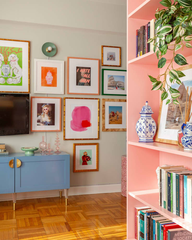 Pink bookshelf in colorful living room.