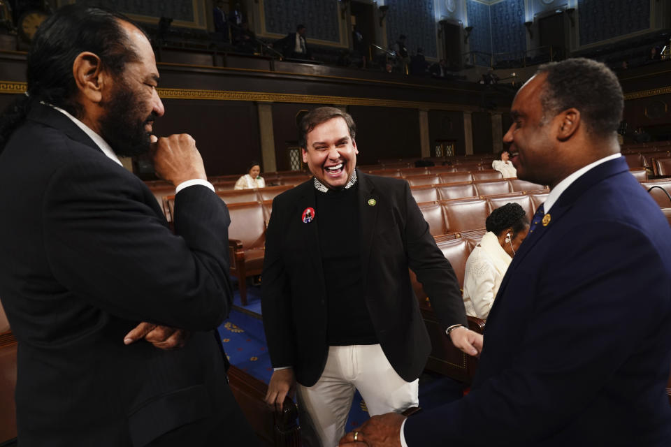 FILE - Former Rep. George Santos, R-N.Y., center, talks with Rep. Al Green, D-Texas, left,and Rep. Joe Neguse, D-Colo., before President Joe Biden delivers the State of the Union address to a joint session of Congress at the Capitol, Thursday, March 7, 2024, in Washington. Santos, who was expelled from the House of Representatives in December and faces federal charges of defrauding donors to his 2022 campaign, announced on social media that he is running for Congress again. (Shawn Thew/Pool via AP, File)