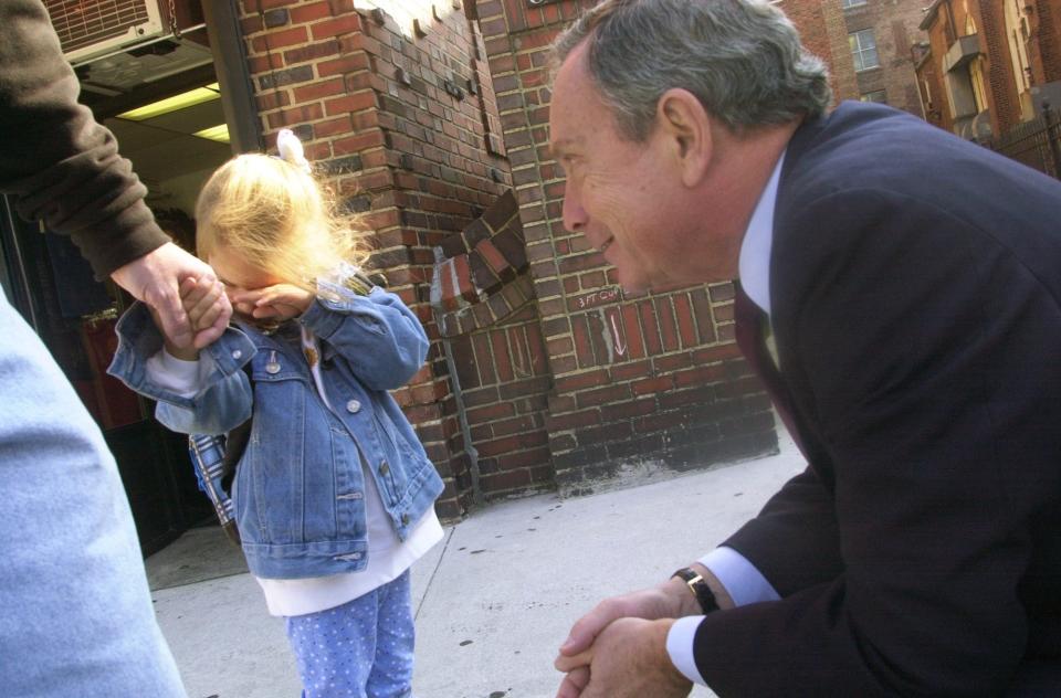 Republican mayoral candidate Michael Bloomberg tries to make friends with a shy Linda McNulty, 4, during a campaign stop in Bay Ridge, Brooklyn.