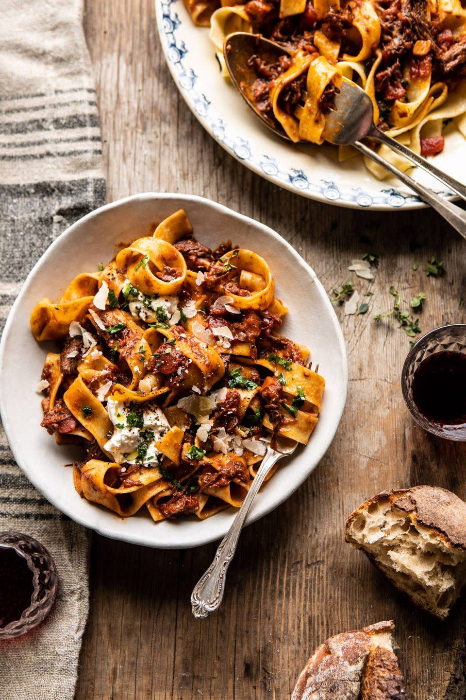 slow cooker red wine sunday ragu with wine glass and bread