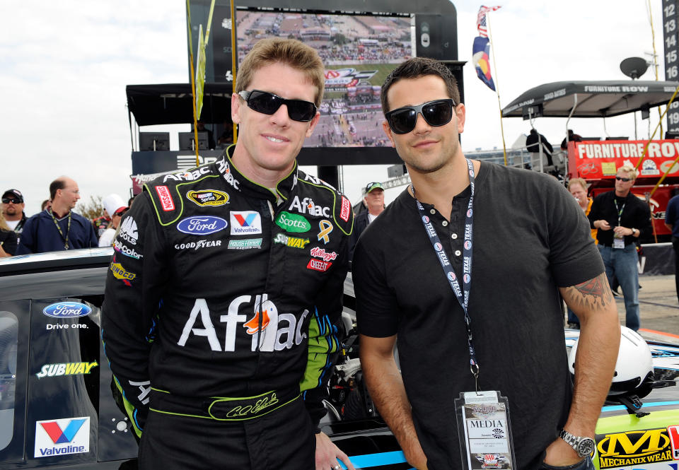 FORT WORTH, TX - NOVEMBER 06: Actor Jesse Metcalfe (R) poses with Carl Edwards (L), driver of the #99 Aflac Ford, on the grid prior to the NASCAR Sprint Cup Series AAA Texas 500 at Texas Motor Speedway on November 6, 2011 in Fort Worth, Texas. (Photo by John Harrelson/Getty Images for NASCAR)