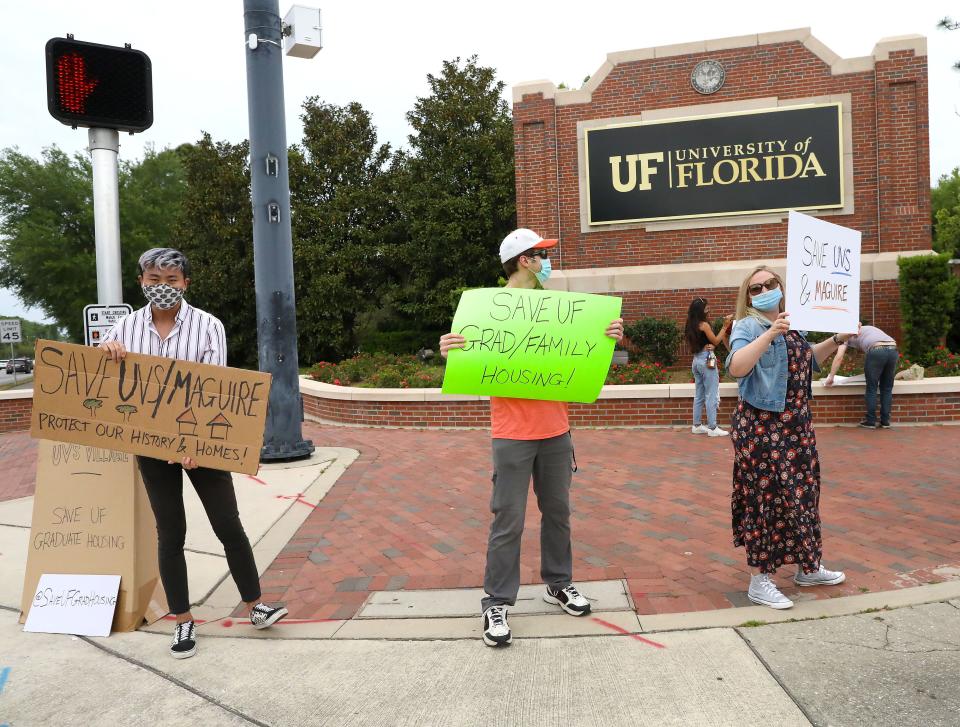 Graduate students hold signs and protest the University of Florida's pan to tear down a pair of affordable grad housing complexes.