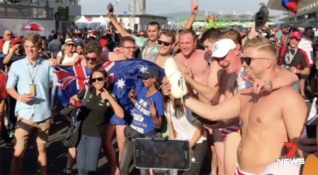 Racegoers taking photos with the men. Source: 7News