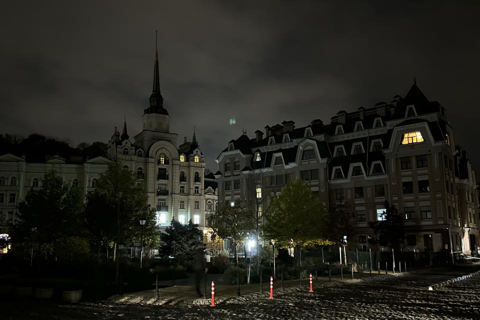 City lighting turned off at twilight in Kyiv downtown, Ukraine, Monday, Oct. 31, 2022. Rolling blackouts are increasing across Ukraine as the government rushes to stabilise the energy grid and repair the system ahead of winter. (AP Photo/Andrew Kravchenko)