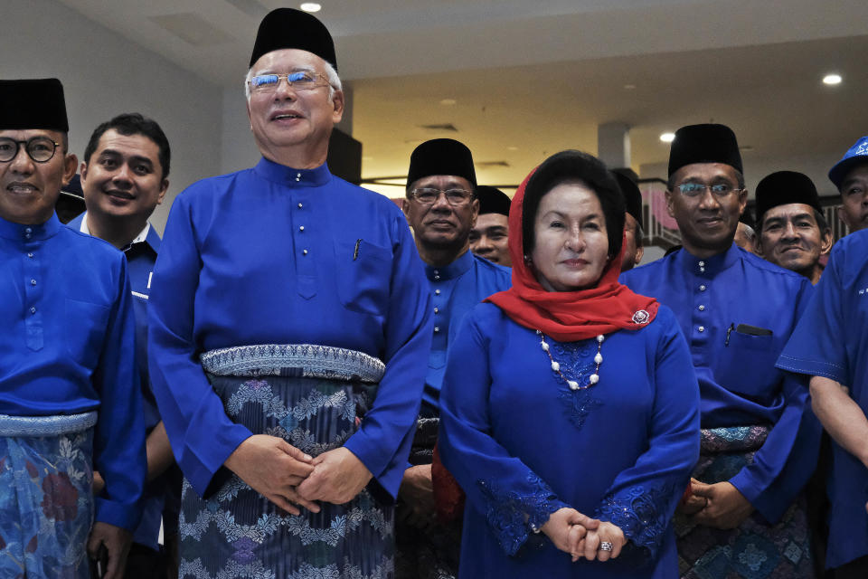 Former Malaysian Prime Minister Najib Razak, second left in front, and his wife Rosmah Mansor prepare to leave for an election nomination center in Pekan, Pahang state, Malaysia, April 28, 2018. Najib Razak on Tuesday, Aug. 23, 2022 was Malaysia’s first former prime minister to go to prison -- a mighty fall for a veteran British-educated politician whose father and uncle were the country’s second and third prime ministers, respectively. The 1MDB financial scandal that brought him down was not just a personal blow but shook the stranglehold his United Malays National Organization party had over Malaysian politics. (AP Photo/Sadiq Asyraf)