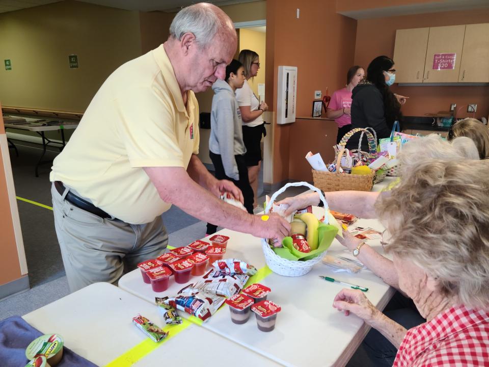 Volunteers fill baskets for the Perry Lutheran Homes' Project Deliver the LOVE initiative on Thursday, May 11, 2023.