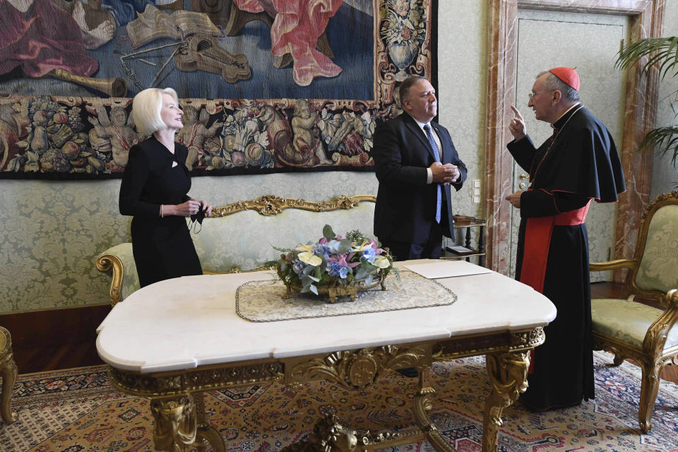 U.S. Secretary of State Mike Pompeo and U.S. Ambassador to the Holy See Callista L. Gingrich, left, meet Vatican Secretary of State Cardinal Pietro Parolin, at the Vatican, Thursday, Oct. 1, 2020. Pompeo is meeting Thursday with top Vatican officials, a day after tensions over U.S. opposition to the Vatican’s China policy spilled out in public. (Vatican Media via AP)