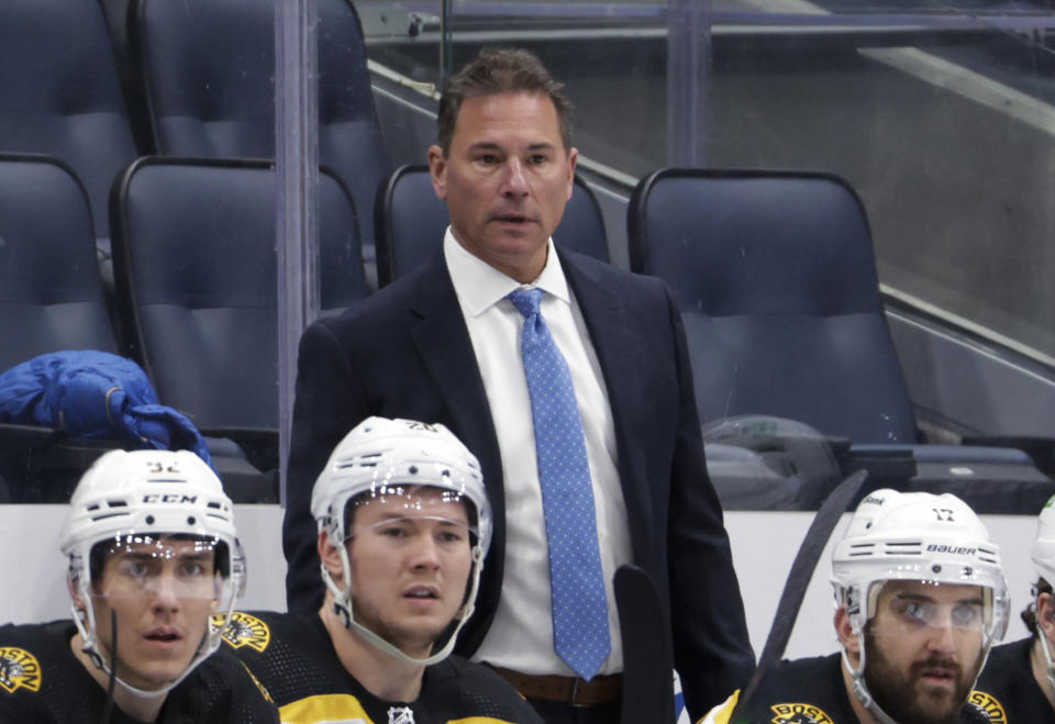 FILE - Boston Bruins coach Bruce Cassidy watches during the third period of the team's NHL hockey game against the New York Islanders on Feb. 17, 2022, in Elmont, N.Y. Boston's Jim Montgomery, Dallas' Pete DeBoer and Vegas' Bruce Cassidy led their teams to the NHL playoffs this season. Montgomery replaced Cassidy and Cassidy replaced DeBoer. (AP Photo/Corey Sipkin, File)