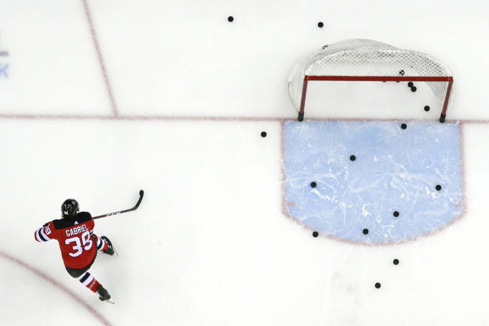 FILE - In this Feb. 17, 2019, file photo, New Jersey Devils right wing Kurtis Gabriel works out prior to an NHL hockey game against the Buffalo Sabres in Newark, N.J. The NHL is hoping to move to Phase 2 of its return-to-play protocol, including the opening of practice facilities and allowing small group workouts, early next month. The league, which was forced to pause its season on March 12 because of the COVID-19 pandemic, released a 22-page memo detailing the plan Monday, May 25, 2020. The document stresses there's no exact date for the start of Phase 2 or a timetable for how long it will last. (AP Photo/Julio Cortez, File)