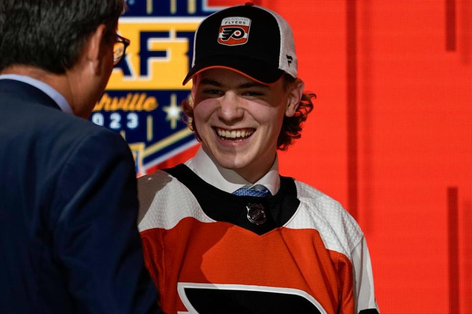 Oliver Bonk smiles on stage after being picked by the Philadelphia Flyers during the first round of the NHL hockey draft Wednesday, June 28, 2023, in Nashville, Tenn.  (AP Photo/George Walker IV)