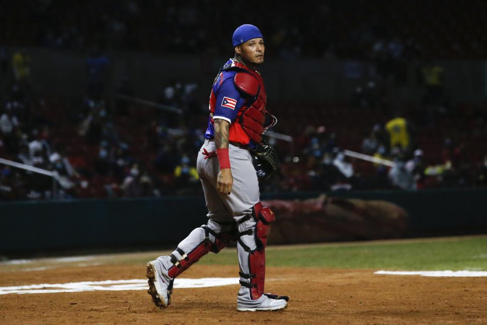 Puerto Rico catcher Yadier Molina walk to the dugout after the first inning against the Dominican Republic in the Caribbean Series baseball final at Teodoro Mariscal stadium in Mazatlan, Mexico, Saturday, Feb. 6, 2021. (AP Photo/Moises Castillo)