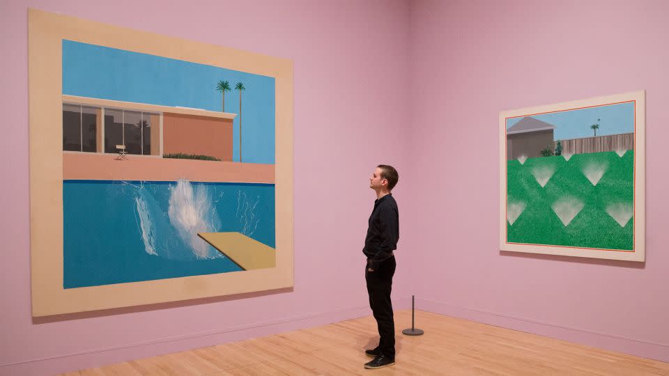 Hockney paintings "A Bigger Splash" (left) and "A Lawn Being Sprinkled." - Daniel Leal/AFP/Getty Images