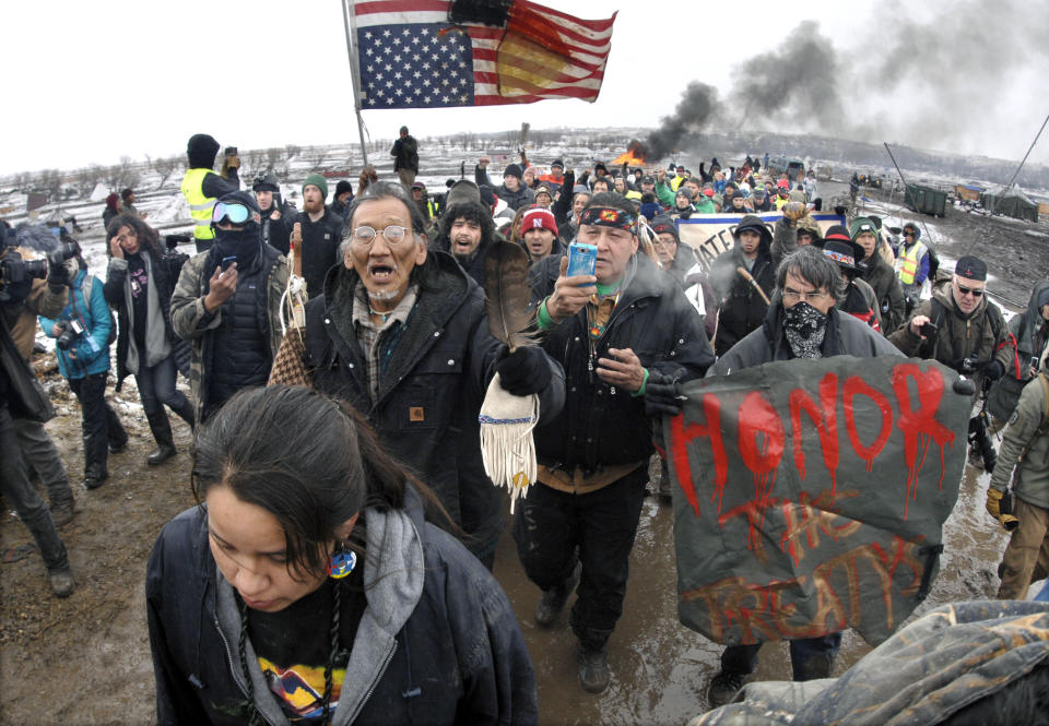 FILE - In this Feb. 22, 2017, file photo, a large crowd representing a majority of the remaining Dakota Access Pipeline protesters march out of the Oceti Sakowin camp before the 2 p.m. local time deadline set for evacuation of the camp mandated by the U.S. Army Corps of Engineers near Cannon Ball, N.D. American Indians from across the country are bringing their frustrations with the Trump administration and its approval of the Dakota Access oil pipeline to the nation's capital Tuesday, March 7, 2017, kicking off four days of activities that will culminate in a march on the White House. (Mike McCleary/The Bismarck Tribune via AP, File)