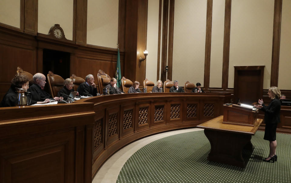 Callie Castillo, right, Deputy Solicitor General for the state of Washington, speaks Tuesday, Jan. 22, 2019, during a Washington Supreme Court hearing in Olympia, Wash., on a lawsuit addressing the constitutional freedom of state presidential electors to vote for any candidate for president, not just the nominee of their party. (AP Photo/Ted S. Warren)