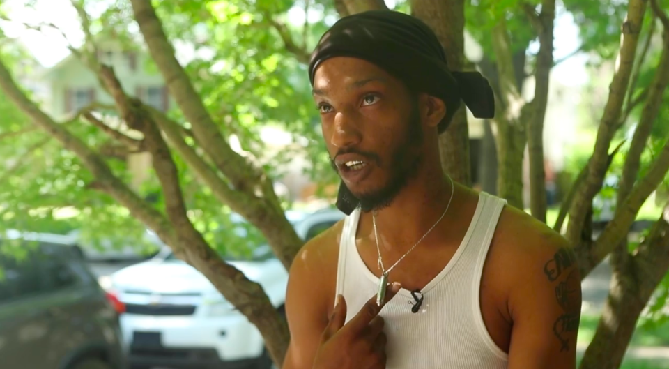 Deonta Words, 25, shows reporters the silver-bullet necklace that used to contain his grandmother's remains. (Photo: Courtesy of The Kansas City Star)