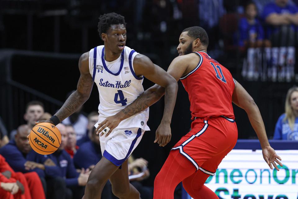 Dec 31, 2022; Newark, New Jersey, USA; Seton Hall Pirates forward Tyrese Samuel (4) dribbles as St. John's Red Storm center Joel Soriano (11) defends during the first half at Prudential Center.