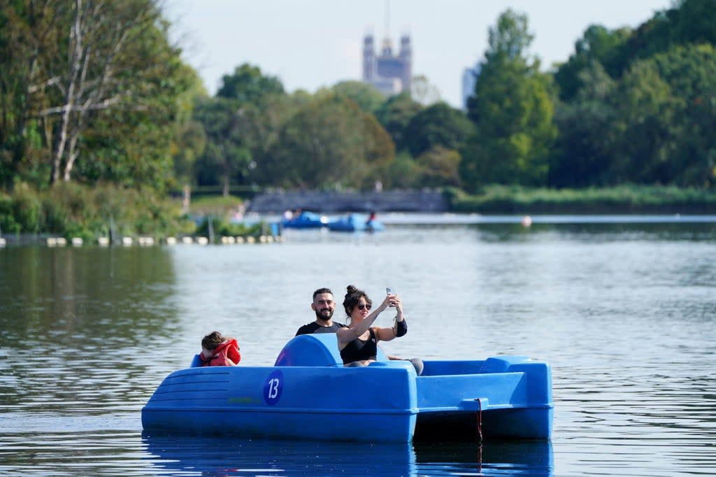 Sun-lovers on the Serpentine in Hyde Park  (PA)