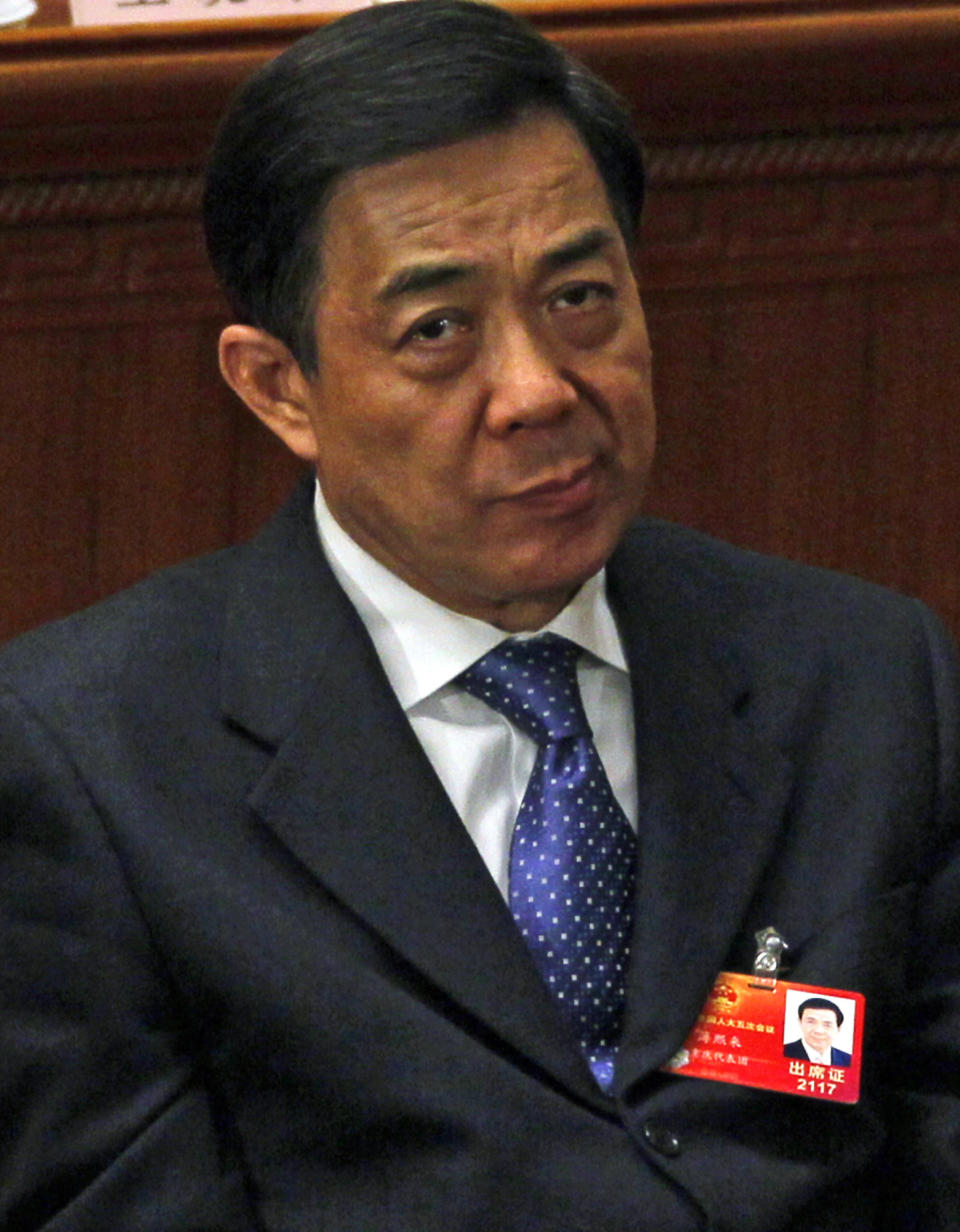 FILE - In this March 9, 2012 file photo, Chongqing party secretary Bo Xilai reacts during a plenary session of the National People's Congress held in Beijing, China. Hours after Gu Kailai poisoned a British businessman, she reached out to a trusted ally: Wang Lijun. Gu was the wife of Bo Xilai and Wang was Bo's chief of police and longtime collaborator. According to an account released Wednesday, Sept. 19, 2012 by the government's Xinhua News Agency, when a panicked Gu turned to Wang for assistance following the murder, Wang helped her cover up the crime. (AP Photo/Ng Han Guan)
