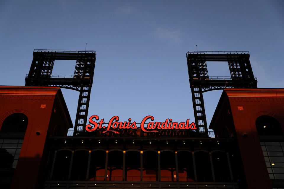 The lights inside an empty Busch Stadium, home of the St. Louis Cardinals, remain off Friday, Aug. 7, 2020, in St. Louis. Major League Baseball announced Friday night that a three-game series between the Chicago Cubs and Cardinals set for this weekend in St. Louis has been postponed after two more Cardinals players and a staff member tested positive for the coronavirus. (AP Photo/Jeff Roberson)