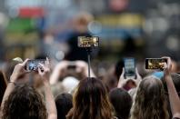 <p>Fans use their smartphones to capture singer-songwriter Ed Sheeran’s performance in New York (Rex features) </p>