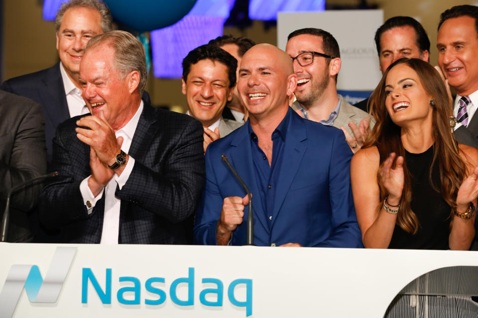 Rapper Pitbull rings the Nasdaq closing bell, joined by L to R: Mark Hoffman (CNBC President), Manny Medina (eMerge founder), Nick Deogan (SVP and EIC, Business News, CNBC), Xavier Gonzalez (ED of eMerge), Melissa Medina (VP of Business Development, eMerge) and Jose Diaz-Balart (anchor, Noticiero Telemundo) at the eMerge Conference on May 4, 2015.