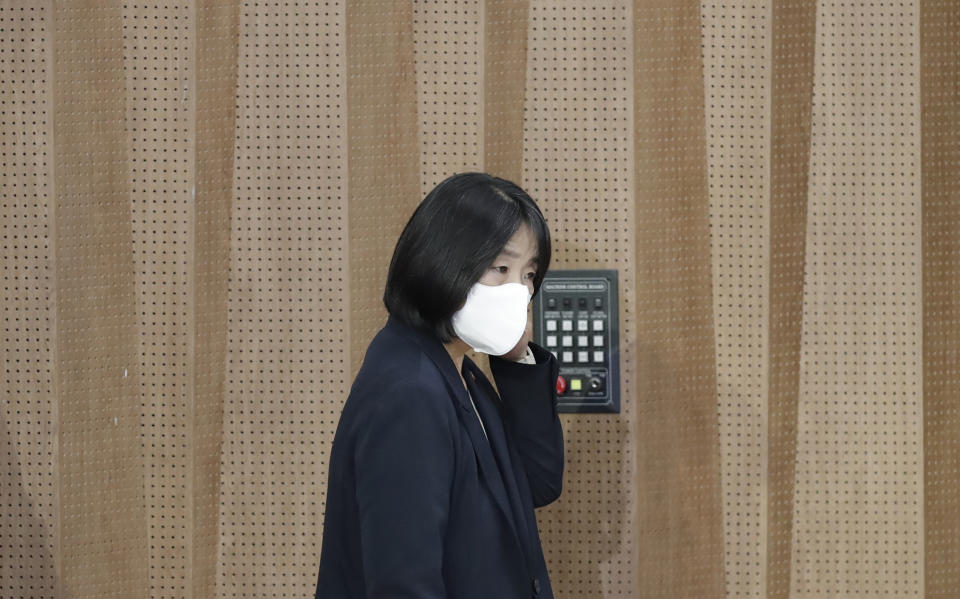 Activist Yoon Meehyang, who begins her four-year term as a lawmaker for the ruling liberal party on Saturday, wearing a face mask, arrives for a news conference at National Assembly in Seoul, South Korea, Friday, May 29, 2020. (AP Photo/Lee Jin-man)