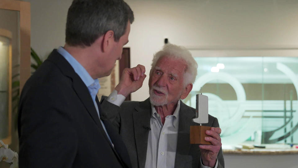 Marty Cooper shows correspondent David Pogue the prototype design for the first cellphone.   / Credit: CBS News