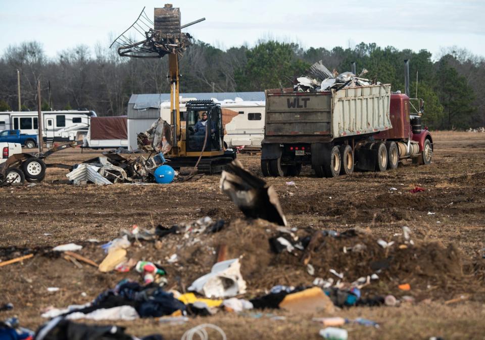 Crews work to clear debris on County Road 140 in Old Kingston, Alabama, on Thursday, Jan. 19, 2023.