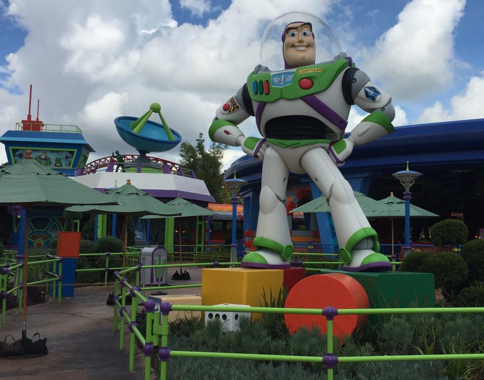 A 14-foot-tall Buzz Lightyear stands watch outside Alien Swirling Saucers in Toy Story Land at Disney's Hollywood Studios.