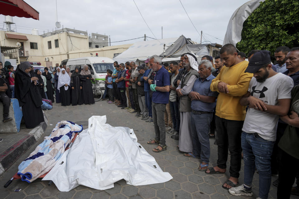 Mourners pray over the bodies of Palestinians who were killed in an Israeli airstrike in Gaza Stirp, at the Al Aqsa hospital in Deir al Balah, Gaza, Thursday, May 2, 2024. (AP Photo/Abdel Kareem Hana)